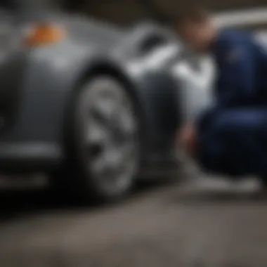 Mechanic inspecting tires of a Toyota Camry